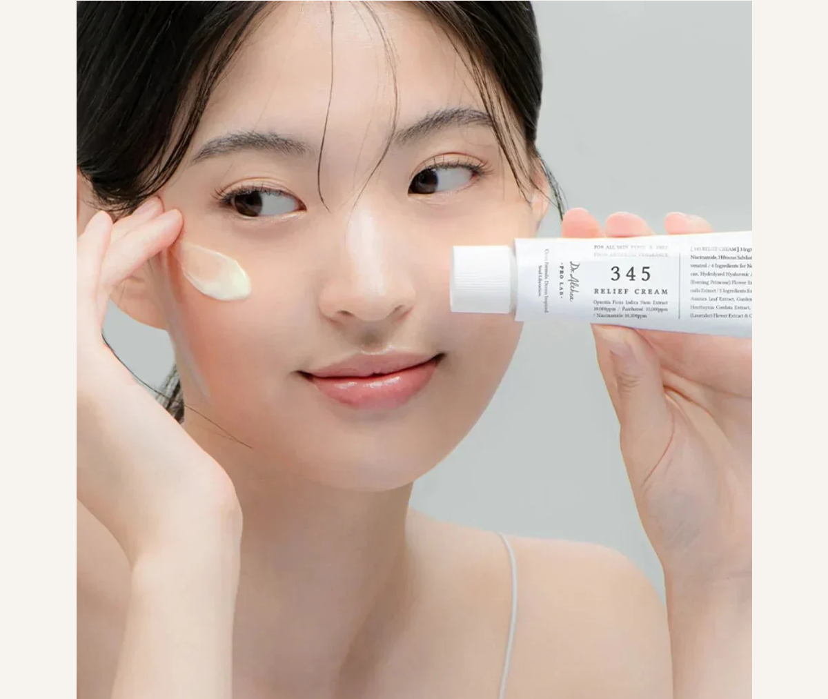 Model applying Dr. Althea 345 Relief Cream
