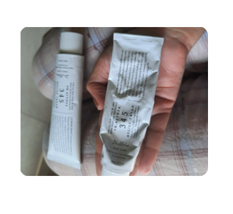 Customer holding used tubes of Dr. Althea 345 Relief Cream